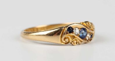 A late Victorian 18ct gold, sapphire and diamond ring, mounted with three cushion cut sapphires