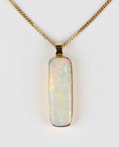 An 18ct gold and opal single stone pendant, mounted with a curved rectangular opal, length 2.9cm,