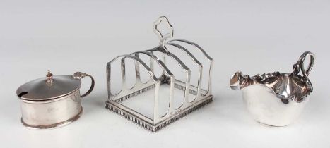 A George V silver four-division toast rack with pierced base, London 1928 by Goldsmiths &