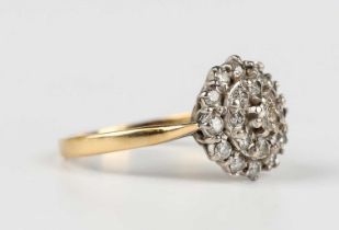 An 18ct gold and diamond cluster ring in a multiple tiered design, mounted with circular cut