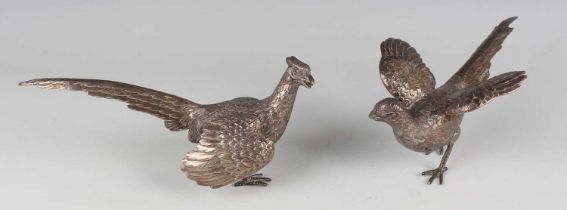 A pair of mid-20th century German silver models of a cock and hen pheasant with engraved plumage,