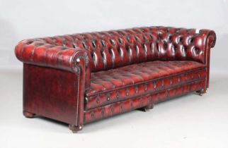 A large modern buttoned claret leather Chesterfield settee, height 78cm, width 245cm, depth 86cm.