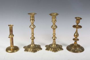 A pair of mid-18th century brass petal-based candlesticks, height 24cm, an 18th century brass