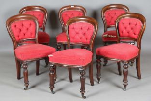 A set of six mid-Victorian mahogany showframe dining chairs, raised on reeded baluster legs,