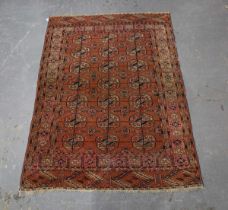 A Tekke rug, West Turkestan, early 20th century, the pale plum field with three columns of guls,