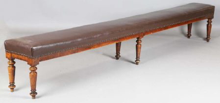 A late Victorian stained beech long rectangular country house hall bench, the overstuffed seat