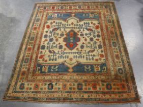 A large Turkish 'Kazak' style carpet, mid/late 20th century, the ivory field with a stepped