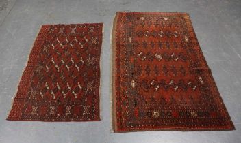 A Turkestan juval, early 20th century, the pale claret field with three columns of guls, 170cm x