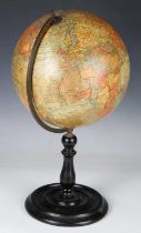 An early 20th century 'Geographia 10 inch Terrestrial Globe', raised on an ebonized stand, height