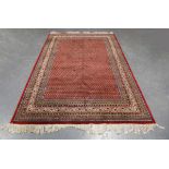 A Serrabend carpet, North-west Persia, late 20th century, the red field with overall offset boteh,