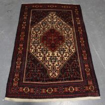 A Senneh rug, North-west Persia, early/mid-20th century, the ivory field with a red medallion,