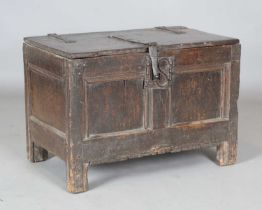 A 17th century oak coffer with large iron strapwork clasp and double panelled front, height 50cm,