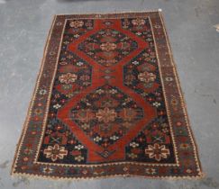 A Kazak rug, West Caucasus, early 20th century, the red field with two bold medallions, within a
