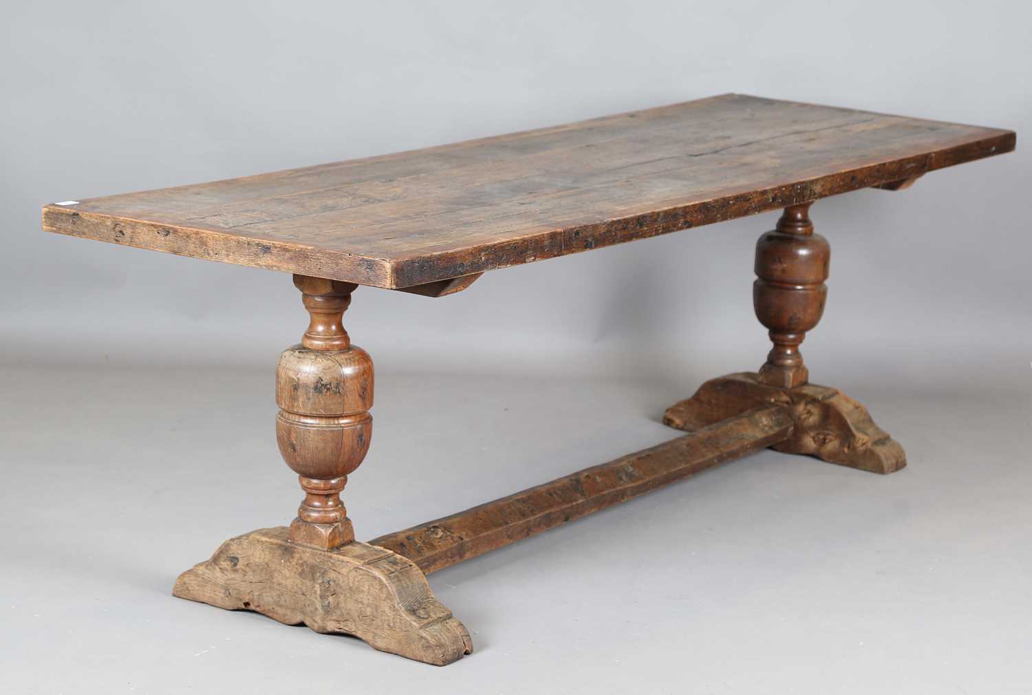 A 17th century style oak refectory table, the top with a walnut crossbanded border, height 74cm,