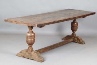 A 17th century style oak refectory table, the top with a walnut crossbanded border, height 74cm,