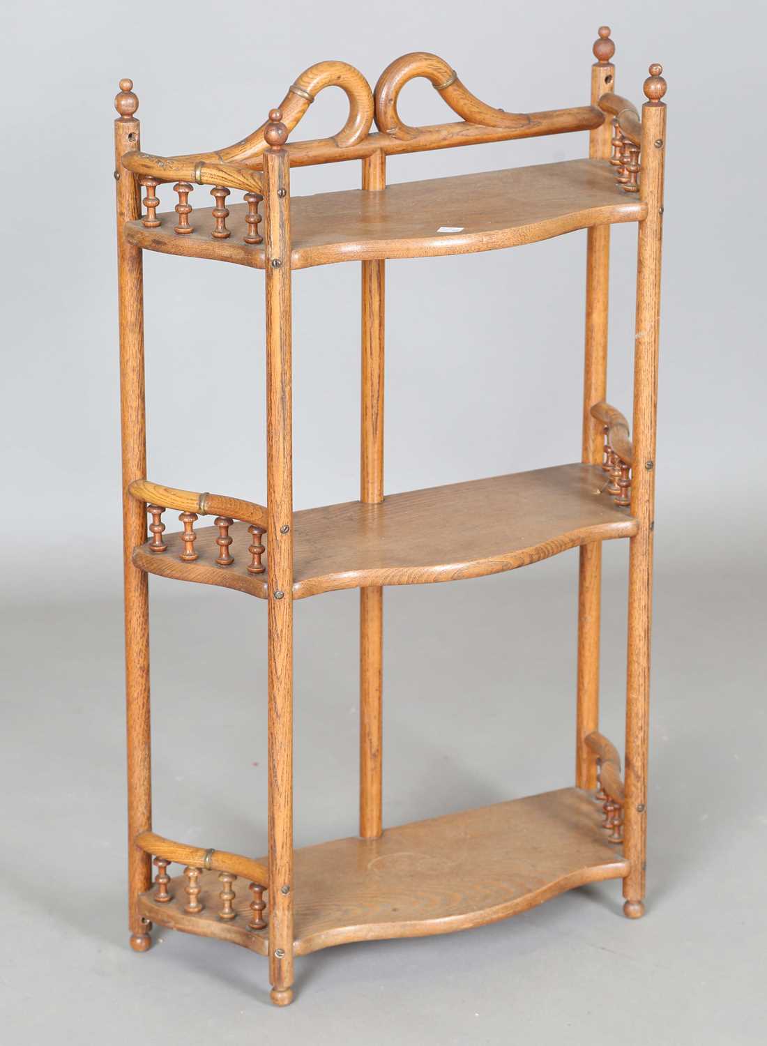 An early 20th century ash and bentwood three-tier wall shelf with applied gilt metal mounts,