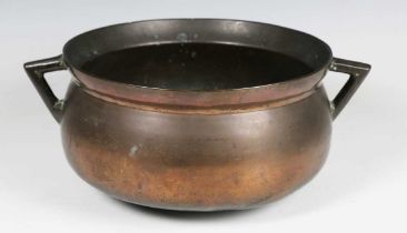 A 17th century copper alloy twin-handled cauldron, width 32cm.