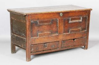 A late 17th century oak coffer, the hinged lid above two drawers, height 75cm, width 133cm, depth