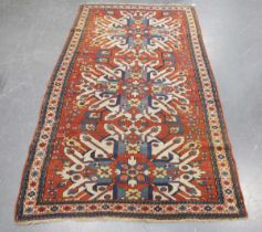A Kazak Chelaberd 'Eagle' rug, late 19th/early 20th century, the terracotta field with three bold