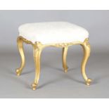 A late 19th century giltwood stool, the seat later upholstered in patterned cream fabric, height