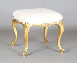 A late 19th century giltwood stool, the seat later upholstered in patterned cream fabric, height