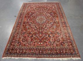 A Heriz carpet, North-west Persia, mid-20th century, the red field with a bold flowerhead medallion,