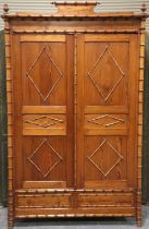 A late 19th century French pitch pine and faux bamboo wardrobe, the two doors enclosing later fitted