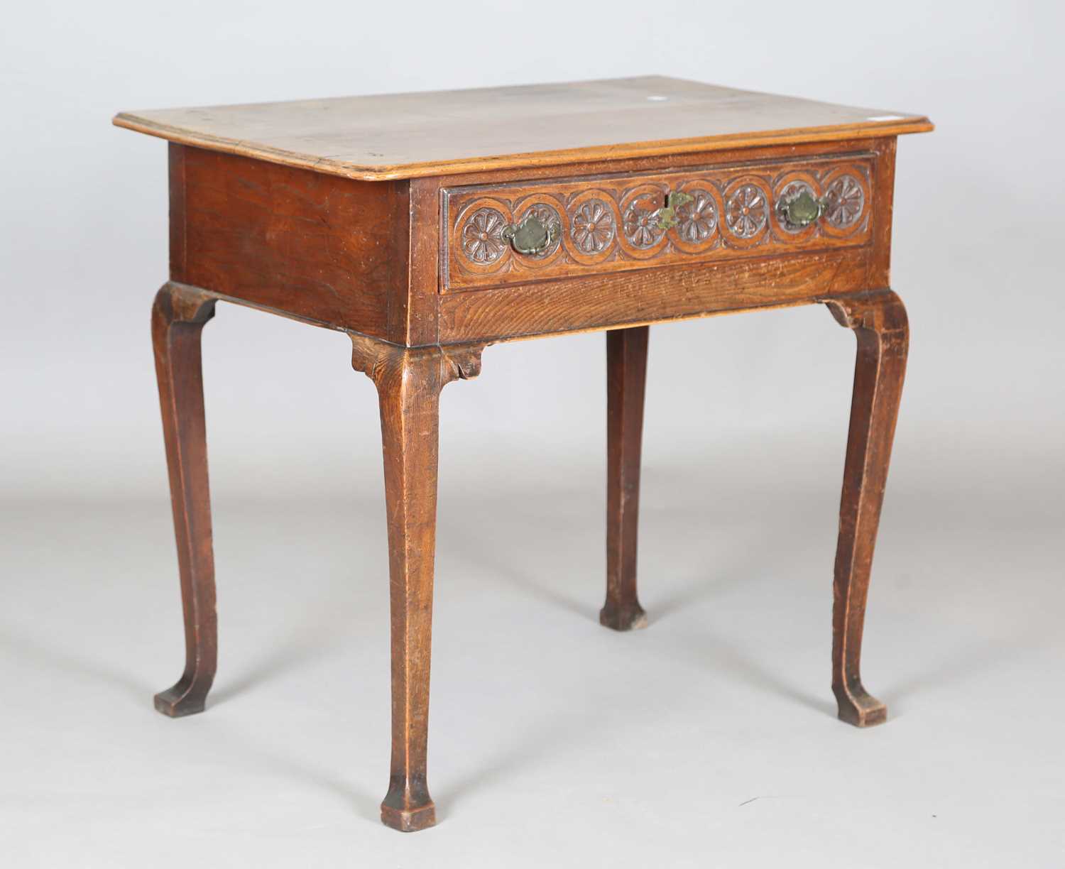 An 18th century elm side table, the single drawer later carved with flowerheads, height 70cm,