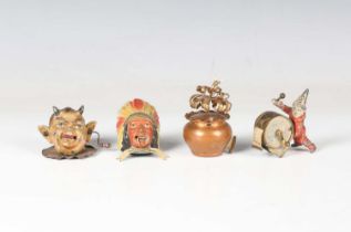 A group of four late 19th/early 20th century novelty tape measures, comprising a devil's head, width
