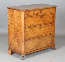 A mid-19th century Continental satin birch chest of four long drawers, on carved scroll feet, height