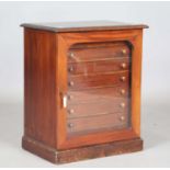 A late Victorian mahogany and stained pine table-top collector's chest, fitted with a glazed door