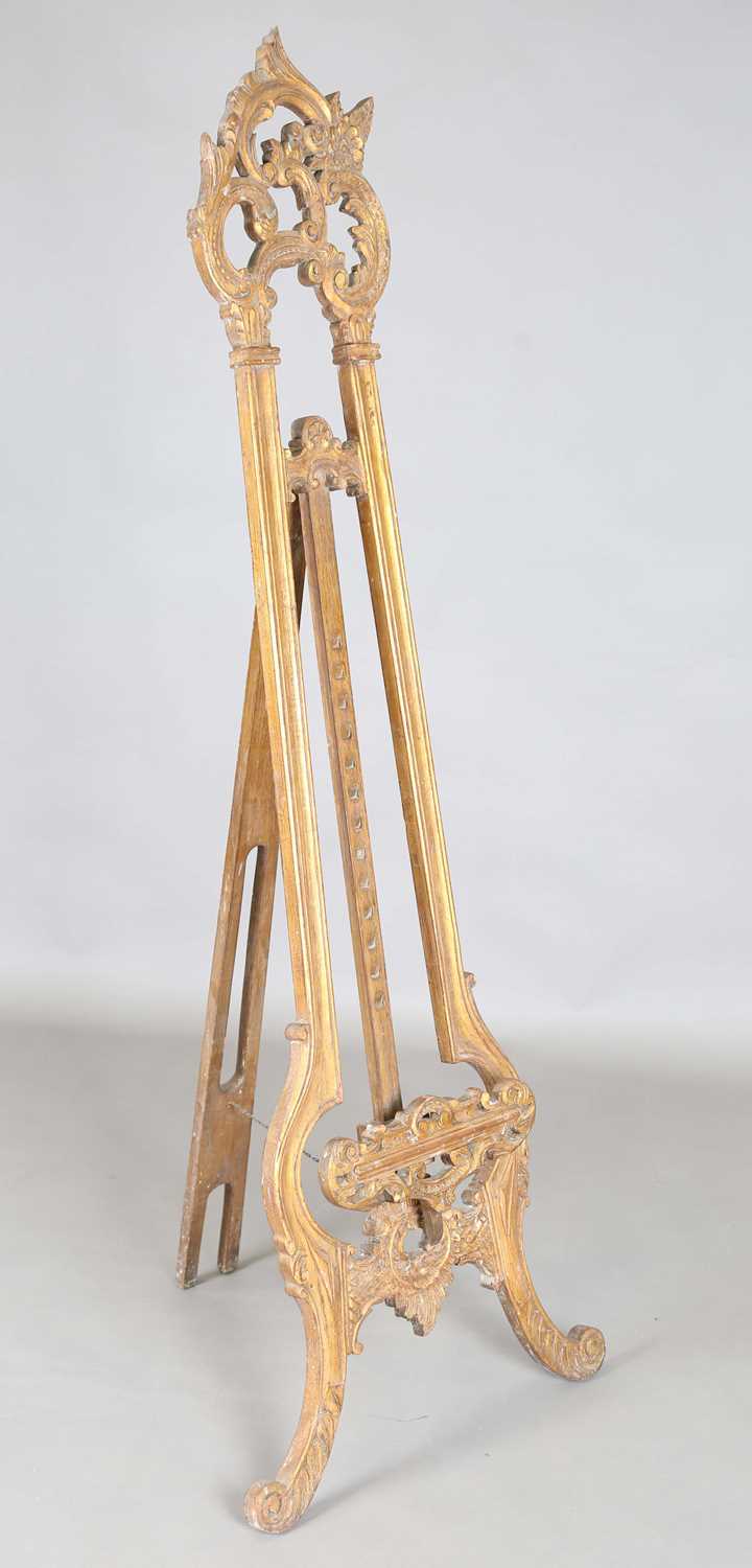 A 20th century rococo style carved wooden easel, height 181cm, width 65cm.