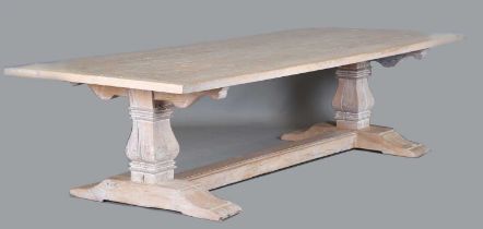 A large late 20th century limed oak refectory table, the four-plank top on a pair of block