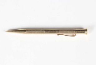 A 9ct gold cased propelling pencil with engine turned decoration and pocket clip, detailed ‘The