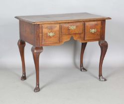 An 18th century oak side table, fitted with three drawers, on cabriole legs with pointed pad feet,