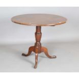 A 19th century provincial oak circular tip-top wine table, on tripod legs, height 72cm, diameter