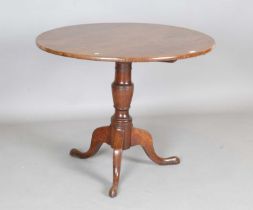 A 19th century provincial oak circular tip-top wine table, on tripod legs, height 72cm, diameter