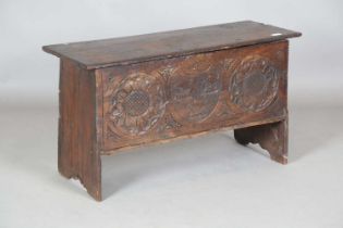 A 17th century oak six-plank coffer with a later carved front, height 53cm, width 94cm, depth
