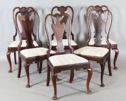 A set of six early 20th century Queen Anne style walnut dining chairs, the vase backs carved with