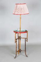 A late 19th/early 20th century bamboo lamp standard with pleated cotton shade and a circular tier