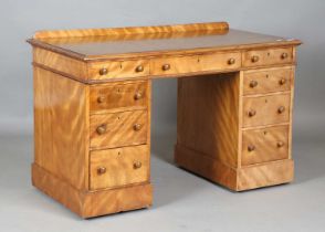 A mid-Victorian satin walnut twin pedestal desk, fitted with an arrangement of ash-lined drawers,