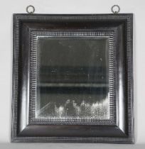 A late 19th century ebonized mirror, the bevelled plate within a Dutch ripple wide section frame,