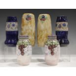 A pair of Royal Doulton stoneware cobalt blue ground vases, decorated by Ethel Bead, monogrammed,