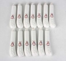 A set of thirteen pistol shaped porcelain knife hafts, late 18th/19th century, of tapered