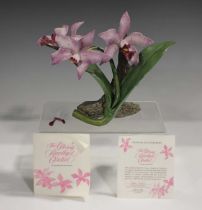 A Franklin Mint porcelain Glossy Amethyst Orchid, modelled by Ronald Van Ruyckevelt, with