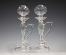 A matched pair of glass lacemaker's lamps, 19th century, the spherical reservoirs raised on baluster
