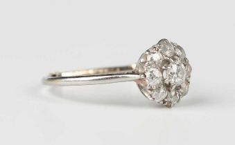 A diamond cluster ring, claw set with the principal old cut diamond within a surround of eight
