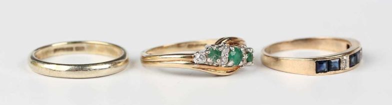 A 9ct gold wedding ring, Sheffield 1988, ring size approx N1/2, a 9ct gold, emerald and diamond