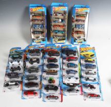 A collection of Mattel Hot Wheels vehicles, all within bubble packs.