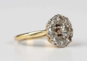 A gold and diamond cluster ring, claw set with the principal circular cut diamond within a